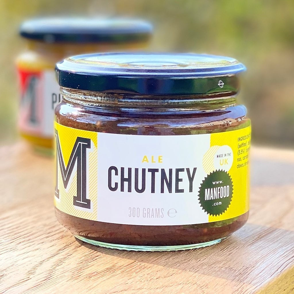 Manfood  Ale Chutney in a glass jar with a yellow label, featuring dark plum and ale ingredients.