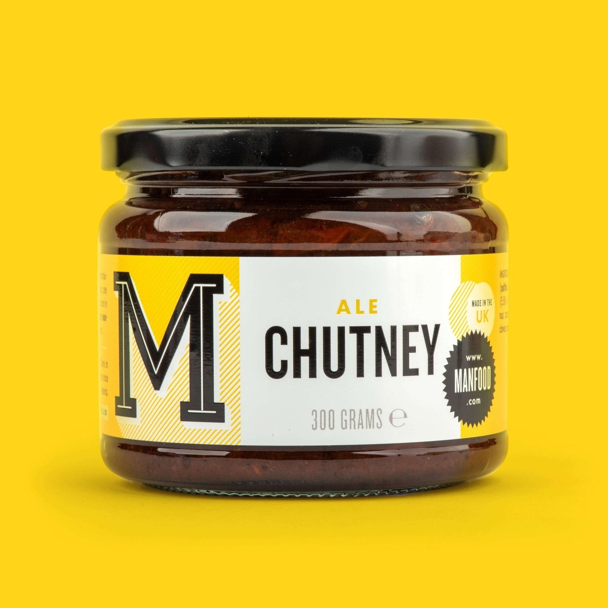 Manfood Ale Chutney in a glass jar with a white and yellow label against a bright yellow background.