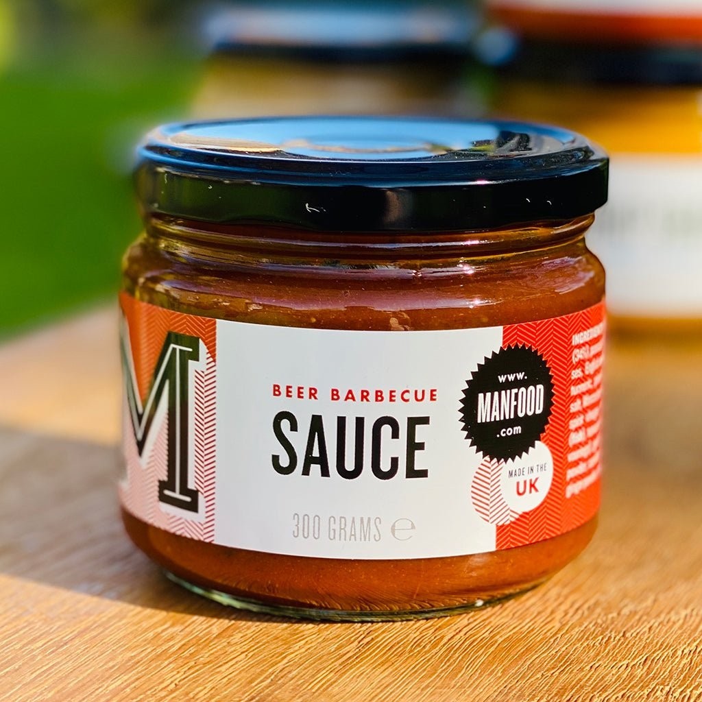 Manfood Beer Barbecue Sauce in a glass jar with a bold red and white label, perfect for grilling and marinating.