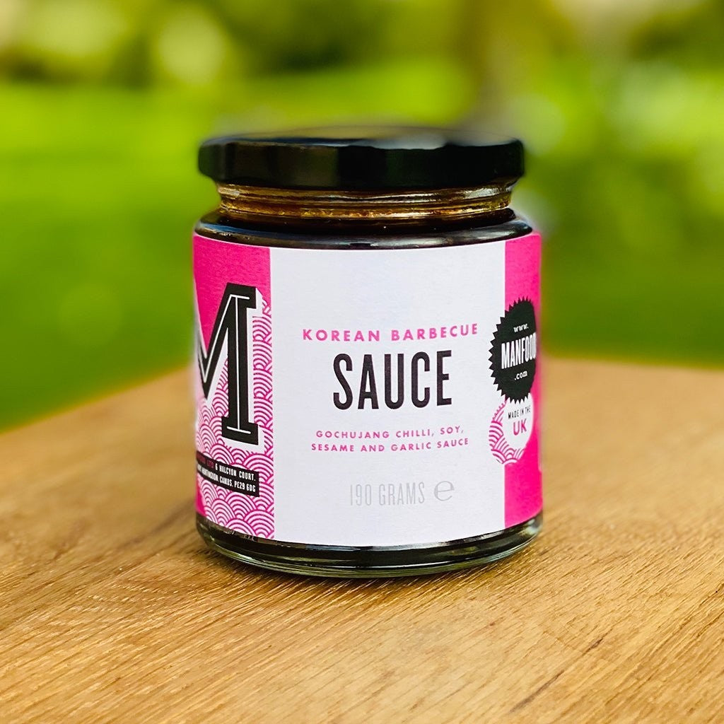 Manfood Korean Barbecue Sauce in a 190g glass jar with a pink and white label on a wooden surface.