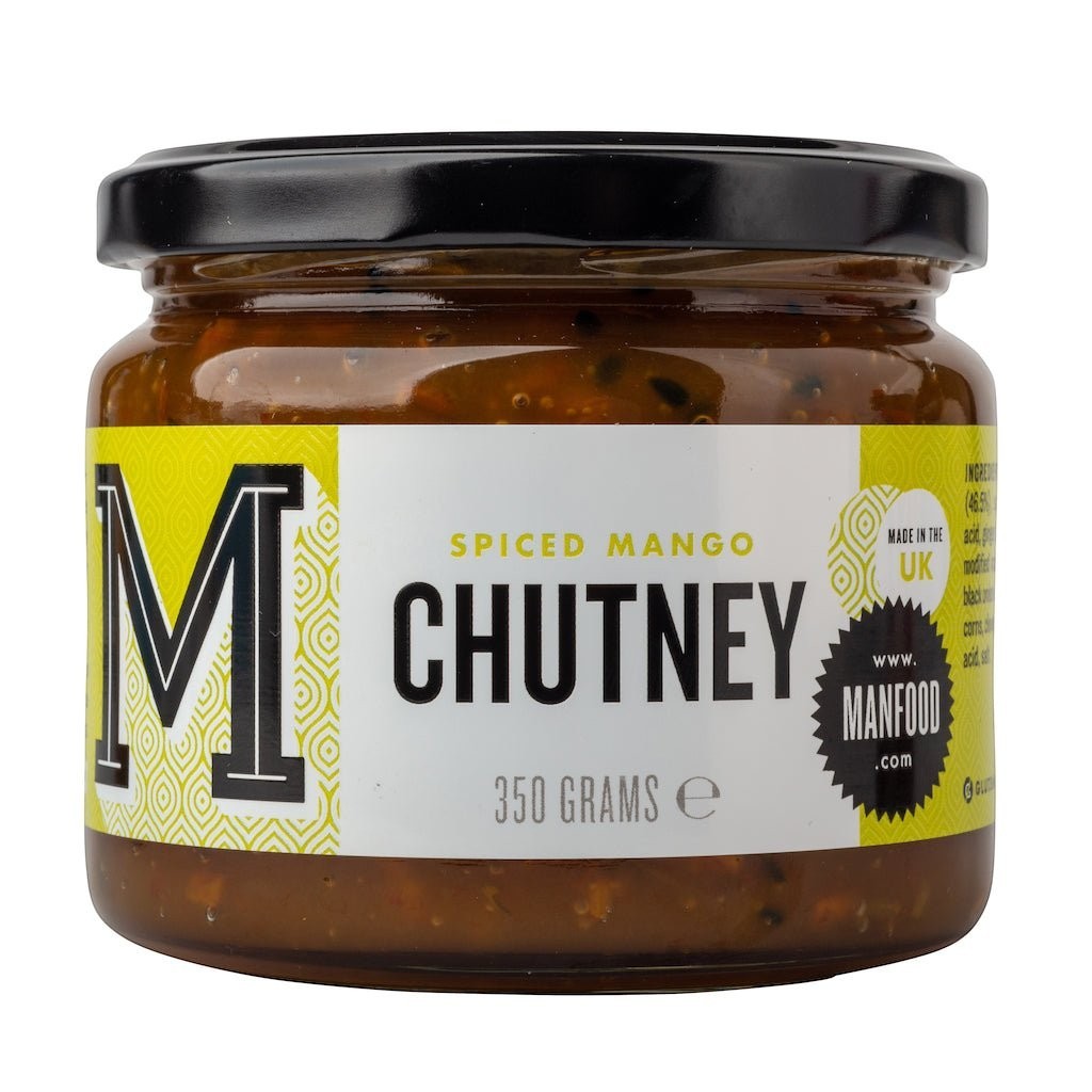 Manfood Cambs spiced mango chutney in a glass jar with a black lid and white label featuring yellow accents.
